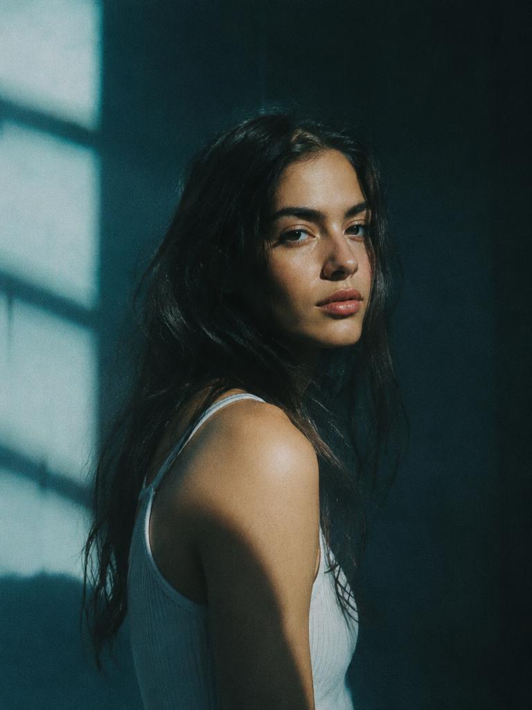 Retrato feminino em luz de janela com sombras azuladas